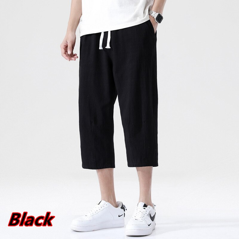 Loose fit 3/4 length mens pants. Features Mid-raise waist,drawstring closure.